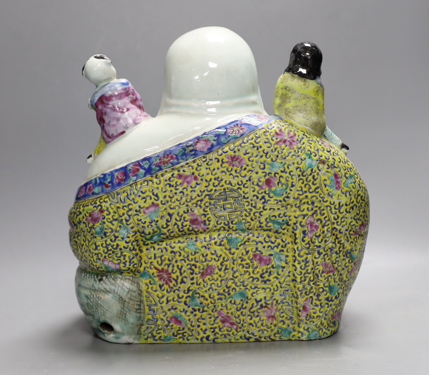 An early 20th century enamelled porcelain figure group of a seated Budai and children, 27.5cm high